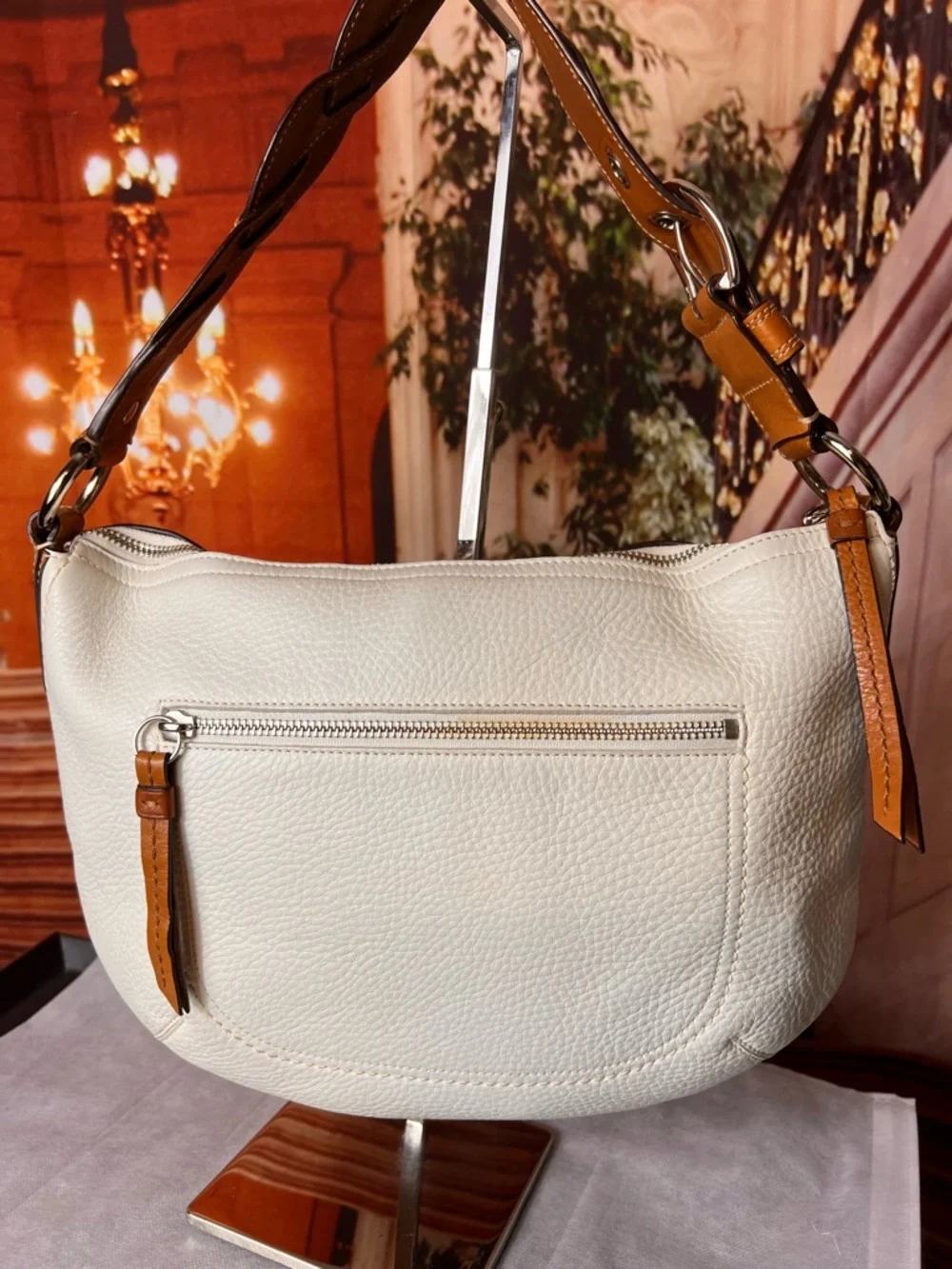 Coach Soho White Pebbled Leather Hobo bag features a distinctive braided handle